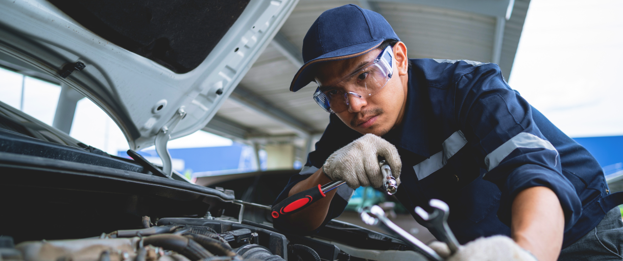 Mechanic working on car engine