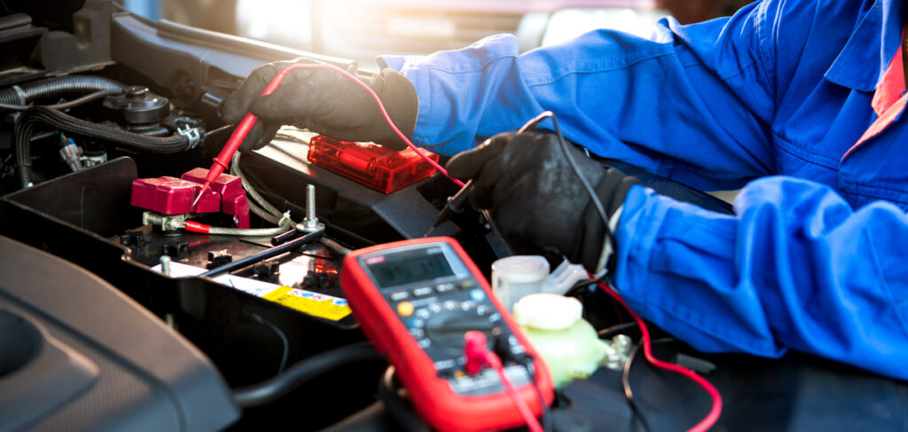 Closeup of mechanic testing car battery